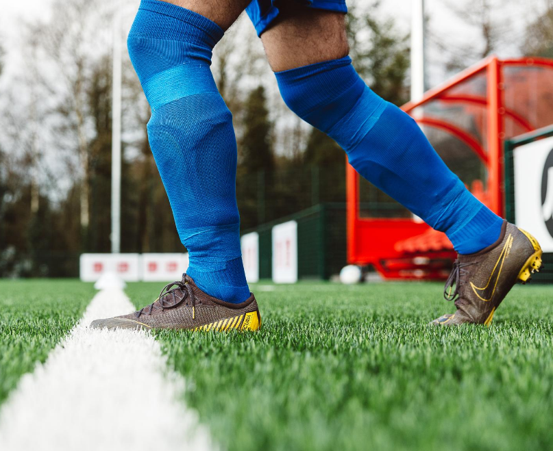 Playing football with cut off socks and blue sock wrap tape