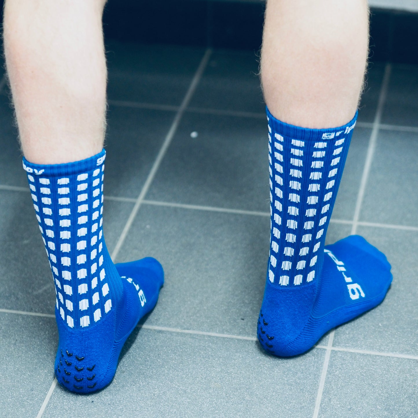 Blue football grip socks grippy sports rear view changing rooms
